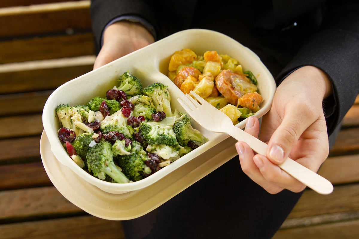 Eating Salads from a Sugarcane 2 compartment Disposable Container