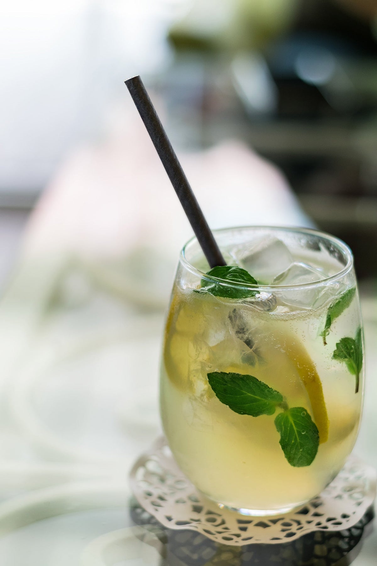 Black Paper Cocktail Straw sitting in a Gin and Tonic with Lemon and Mint